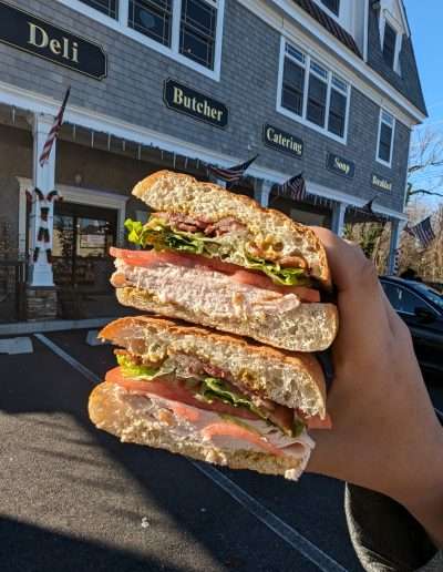 Eating burger outside a deli